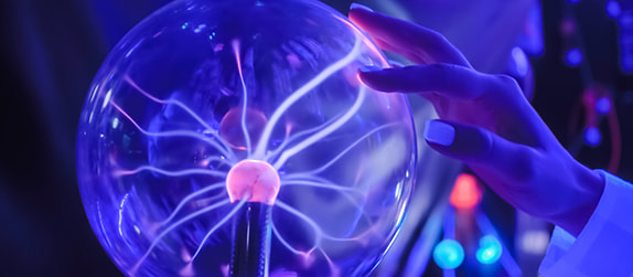 A child touches a plasma ball in a science museum